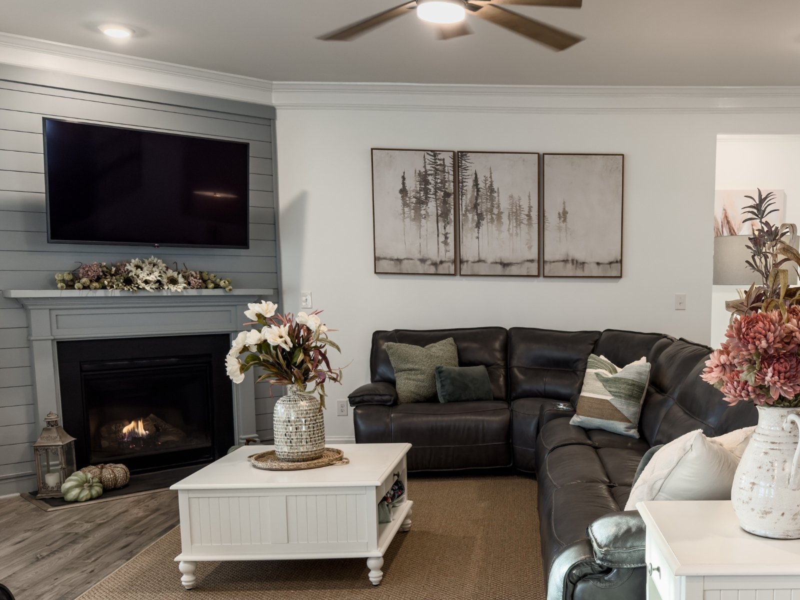 Styled living room interior with coordinated furnishings, artwork, and decor
