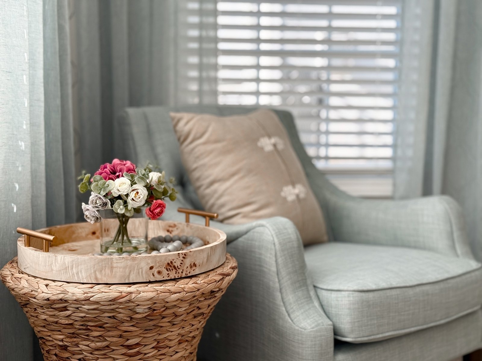 Cozy living room styling with accent chair, side table, and soft decorative elements