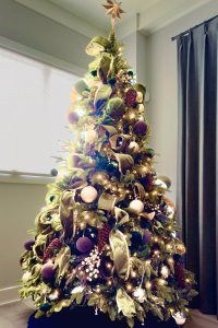 Luxury Christmas tree installation with custom ribbon, ornaments, and lighting by Enchanted Journey Design